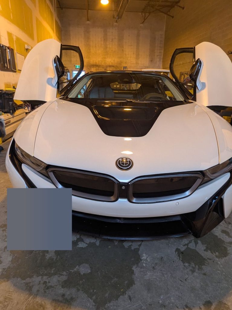 White BMW i8 hood after paintless dent repair