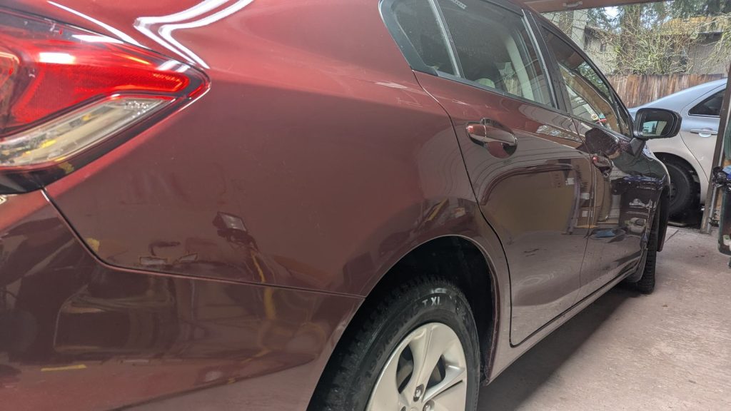 Burgundy hatchback rear quarter after paintless dent repair