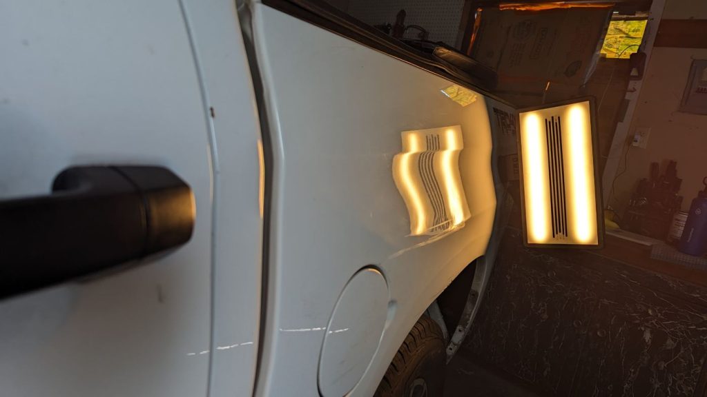 PDR light board on a white pickup door showing a crease
