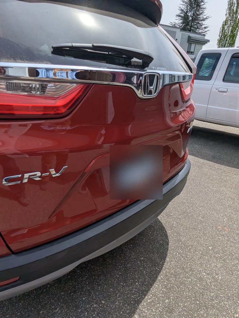 Red Honda CR-V tailgate after paintless dent repair