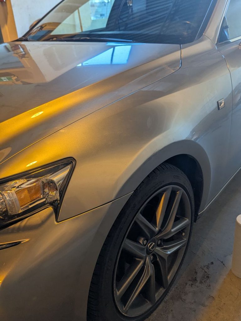 Grey sedan front fender after paintless dent repair