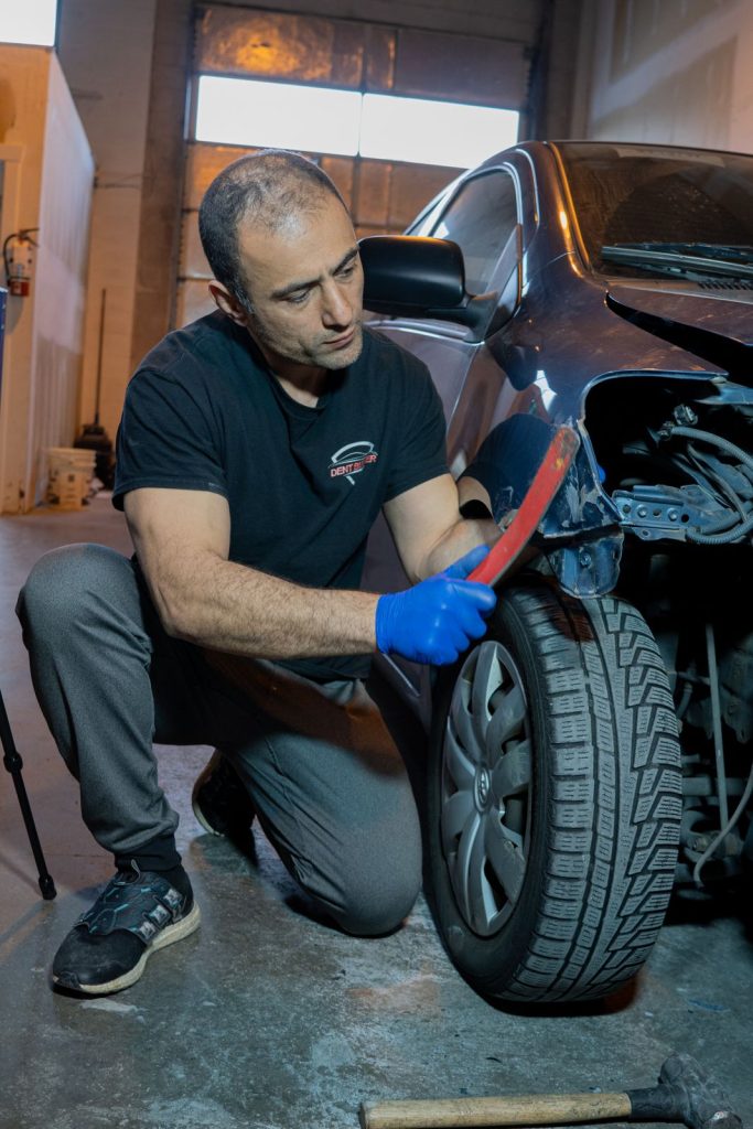 Checking fender damage in the shop