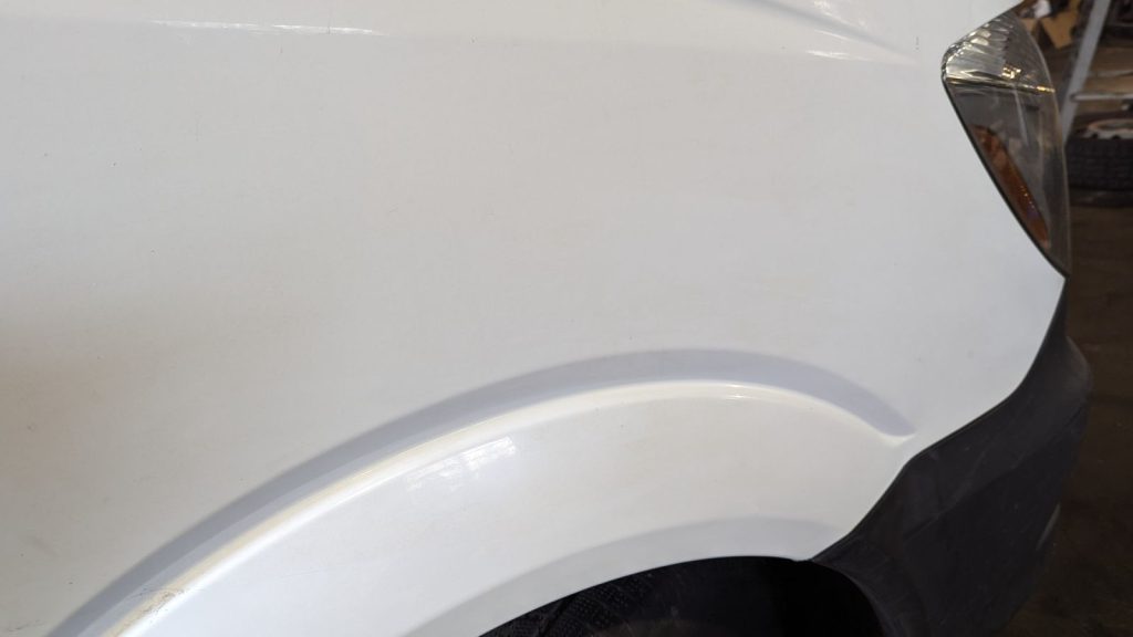 White SUV front fender after paintless dent repair