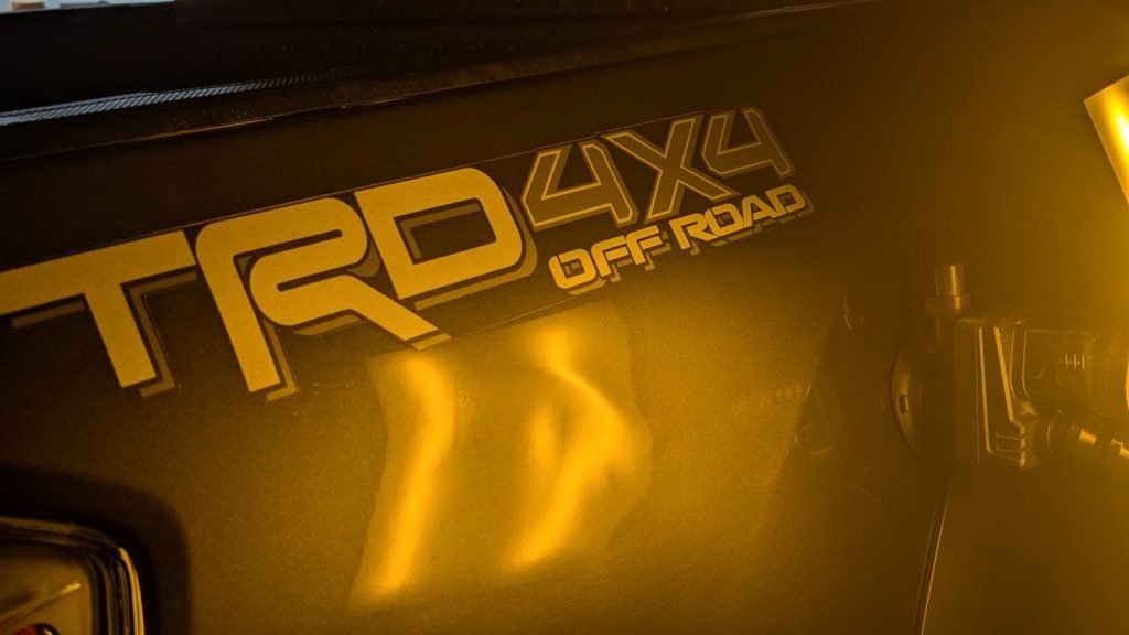 Dent in the bedside of a Toyota Tacoma TRD under PDR light